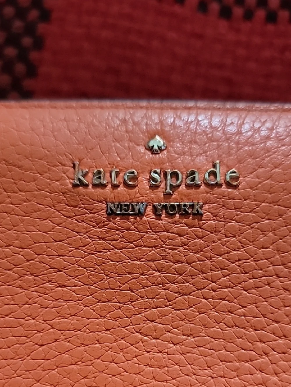 kate spade coral orange pebble leather zip-around wallet